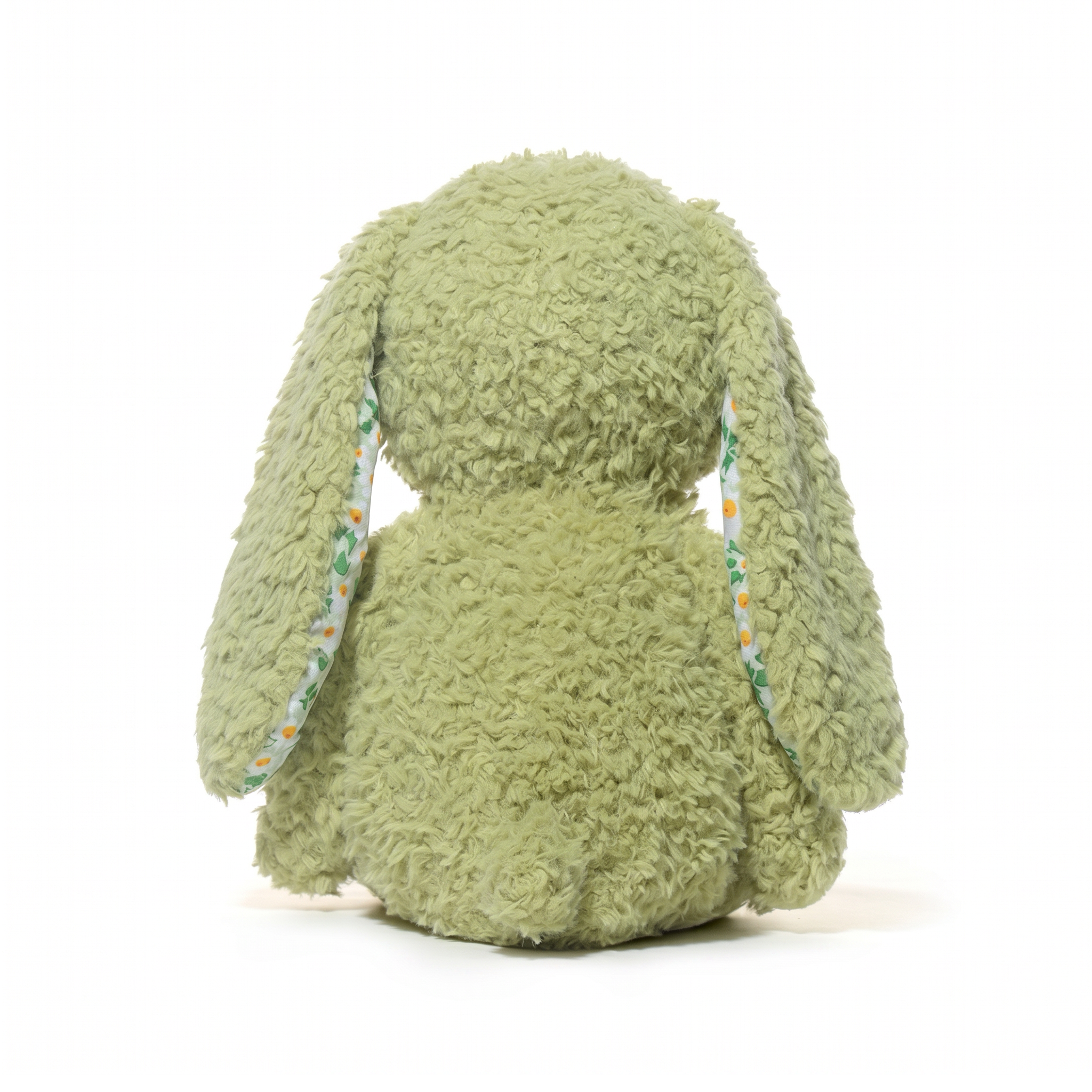 Green plush bunny in a white background