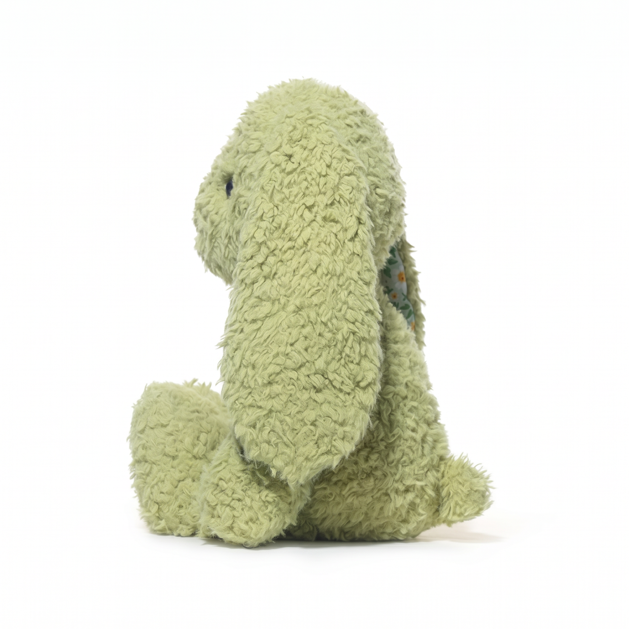 Green plush bunny in a white background